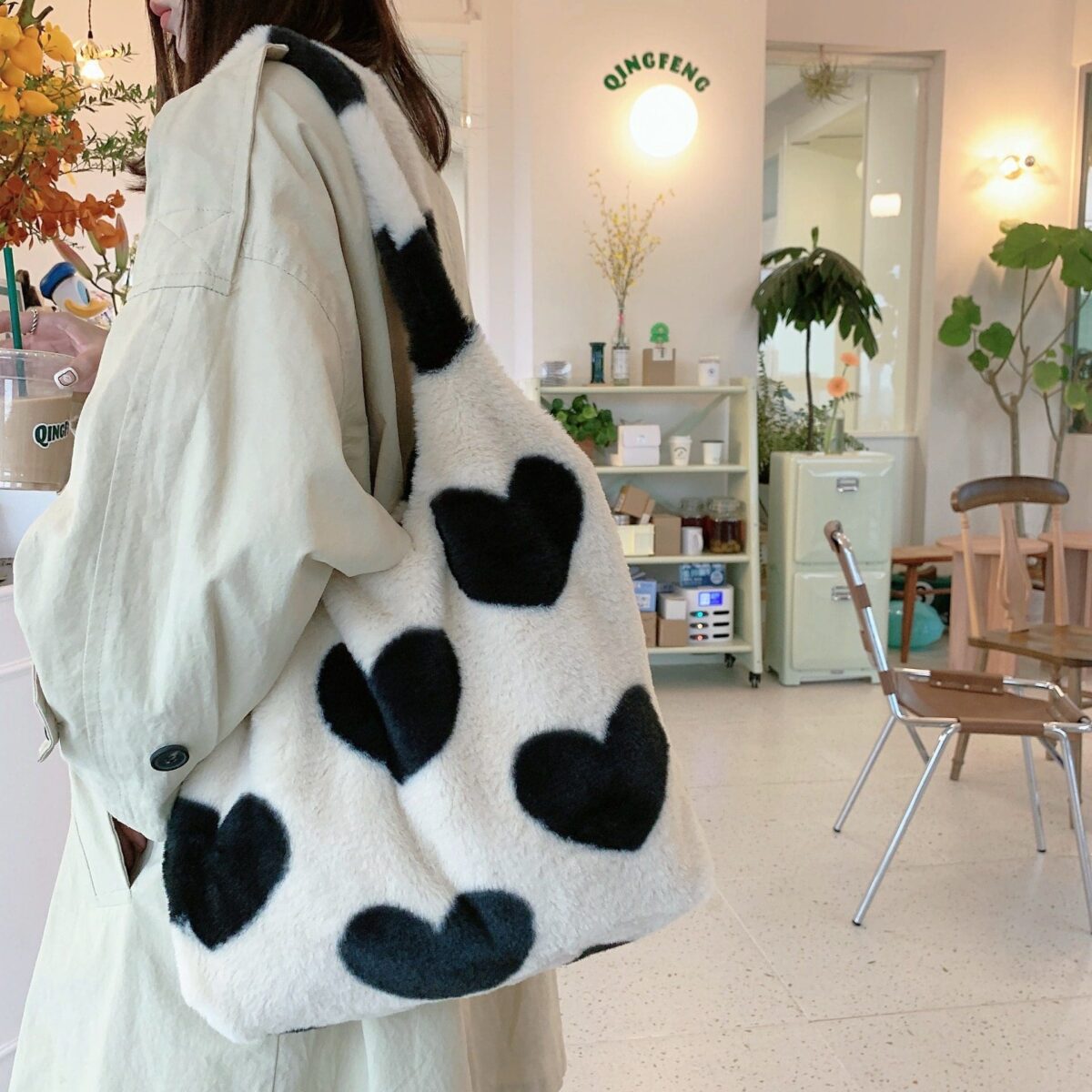 <ul> <li><strong>Luxurious Plush:</strong> Soft, high-quality fabric for a chic feel.</li> <li><strong>Trendy Design:</strong> Love pattern and vertical square shape.</li> <li><strong>Functional Features:</strong> Latch closure, certificate bag, and soft handles.</li> <li><strong>Versatile Colors:</strong> Available in Beige and Black.</li> </ul>