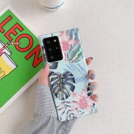 Electroplating Laser Flower Samsung Phone Case on a white surface with tropical leaf design and pastel colors, showcasing modern accessory style.