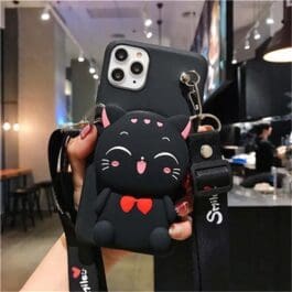 Cartoon Silicone Wallet Case featuring a cute black cat design with prominent ears and red bow tie, attached to a smartphone held in a person’s hand.