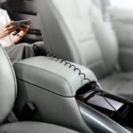 Spring Stretching Data Cable connected to a smartphone in a car’s interior, showcasing its flexible design and utility for on-the-go charging solutions.