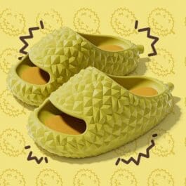 A pair of yellow slippers featuring a playful pineapple design, labeled as "Durian Slippers," perfect for casual wear.