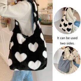 A person carrying a black and white love heart shoulder bag. Small inset images show the bag's gray side and its detail. Text reads: "It can be used two sides.