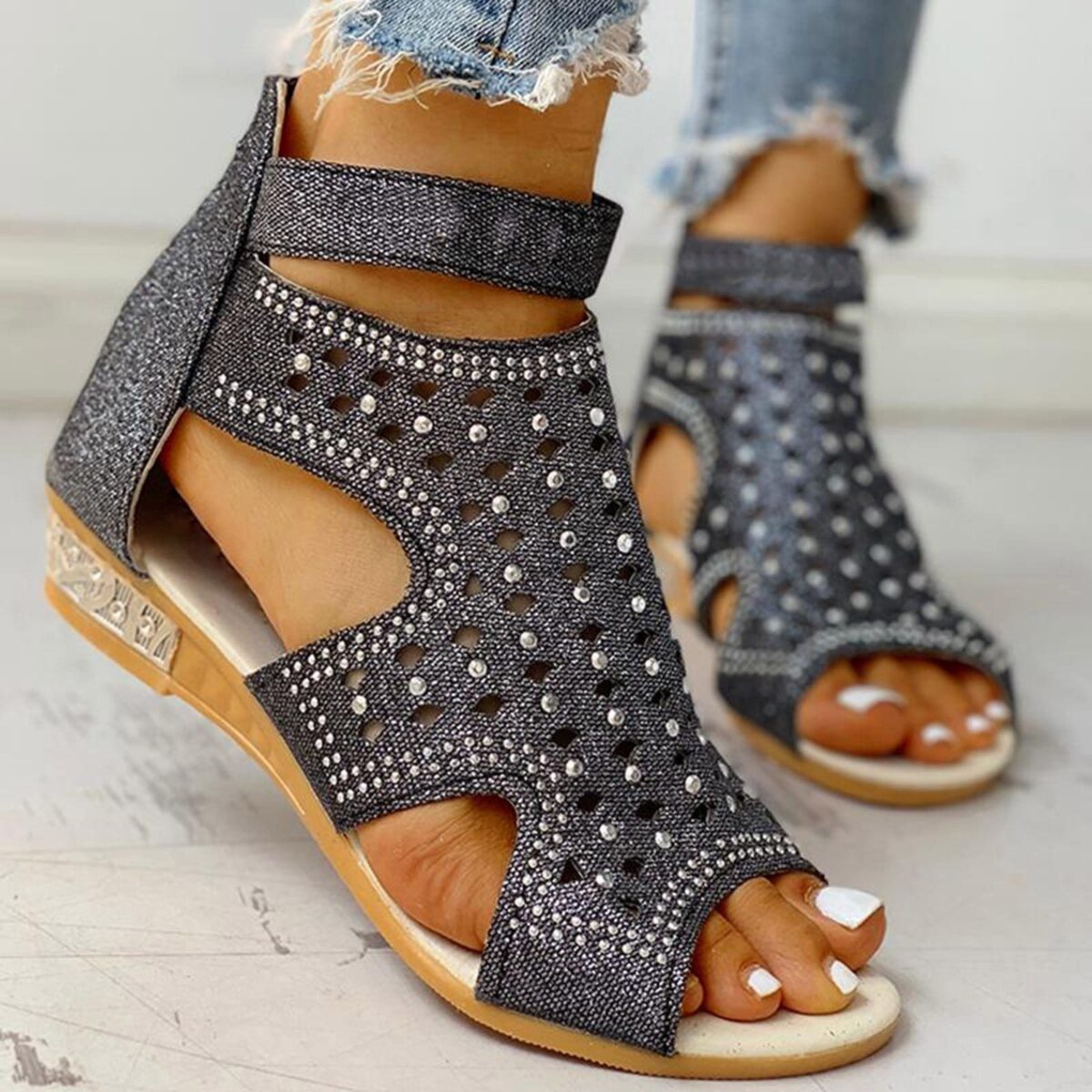 Women's rhinestone sandals featuring studded straps and a stylish buckle for a chic summer look.