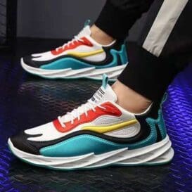 Person wearing colorful, trendy Fashion Running Walking Sports Shoes on a textured floor.