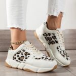 Stylish printed leopard sneakers for women, showcasing a unique blend of white and black patterns for a fashionable appeal.