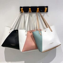 Collection of Women’s Fashionable Splicing Shoulder Bags displayed against a white background, featuring a variety of colors including black, white, pink, and blue with unique color-block designs and elegant shoulder straps.