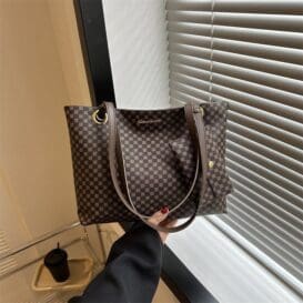 Large Capacity Retro Shoulder Underarm Bag with a classic brown checkered pattern, held against a modern interior background, showcasing the bag’s spacious design and versatile style.