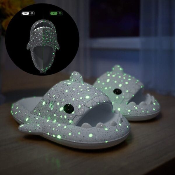 Glow-in-the-dark shark slippers featuring bright eyes, perfect for cozy nights and playful adventures at home.