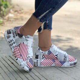 A woman showcases her stylish American flag print sneakers, embodying casual fashion with a platform design.