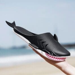 Colorful shark-themed slippers for women, men, and kids. These unique slides feature shark designs, plush cushioning, and non-slip soles, making them perfect for both indoor and outdoor wear.