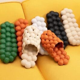 Colorful collection of Creative Herringbone Thick-Soled Slippers displayed on a yellow background. These slippers feature a unique herringbone pattern and thick soles for both comfort and style.