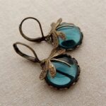 Elegant Vintage Dragonfly Pendant Earrings featuring detailed metalwork and vibrant turquoise gemstones, perfect for adding a touch of antique charm to any outfit.