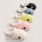 Four colorful slippers featuring a whale face, designed for men and women, made of non-slip indoor cotton material.