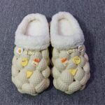 A pair of yellow and white fashion slippers featuring a non-slip litchi bubble design for comfort and style.