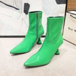 Women’s Pointed Toe Ankle Boots in vibrant green color with a glossy finish, displayed against a minimalist background, highlighting the sleek and fashionable design.