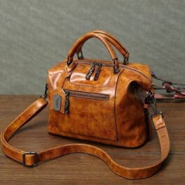 Retro Style Women’s Crossbody Bag with adjustable strap and polished hardware on a wooden surface.