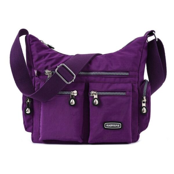 Retro nylon shoulder bag for women in vibrant purple with multiple pockets and silver-tone hardware accents