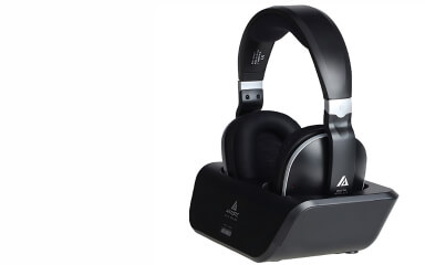 A sleek pair of black wireless over-ear headphones resting on a matching charging dock against a white background, highlighting modern audio technology.